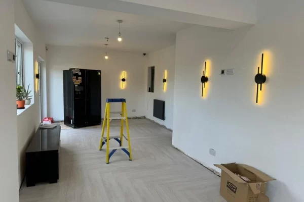 Part of a new kitchen extension with modern wall lights installed.